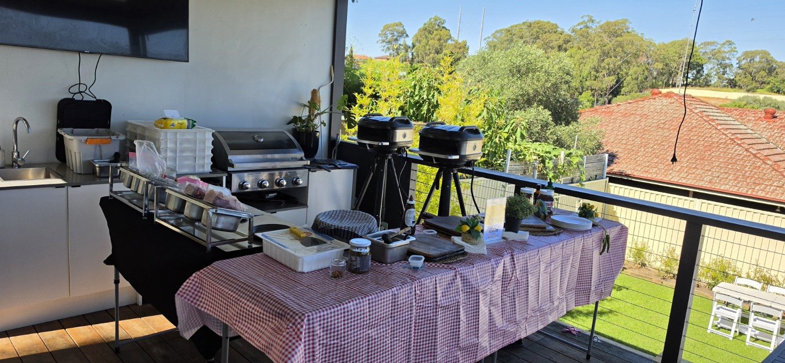 Azzurri pizza catering setup on a Sydney rooftop terrace with twin mobile pizza ovens and BBQ station