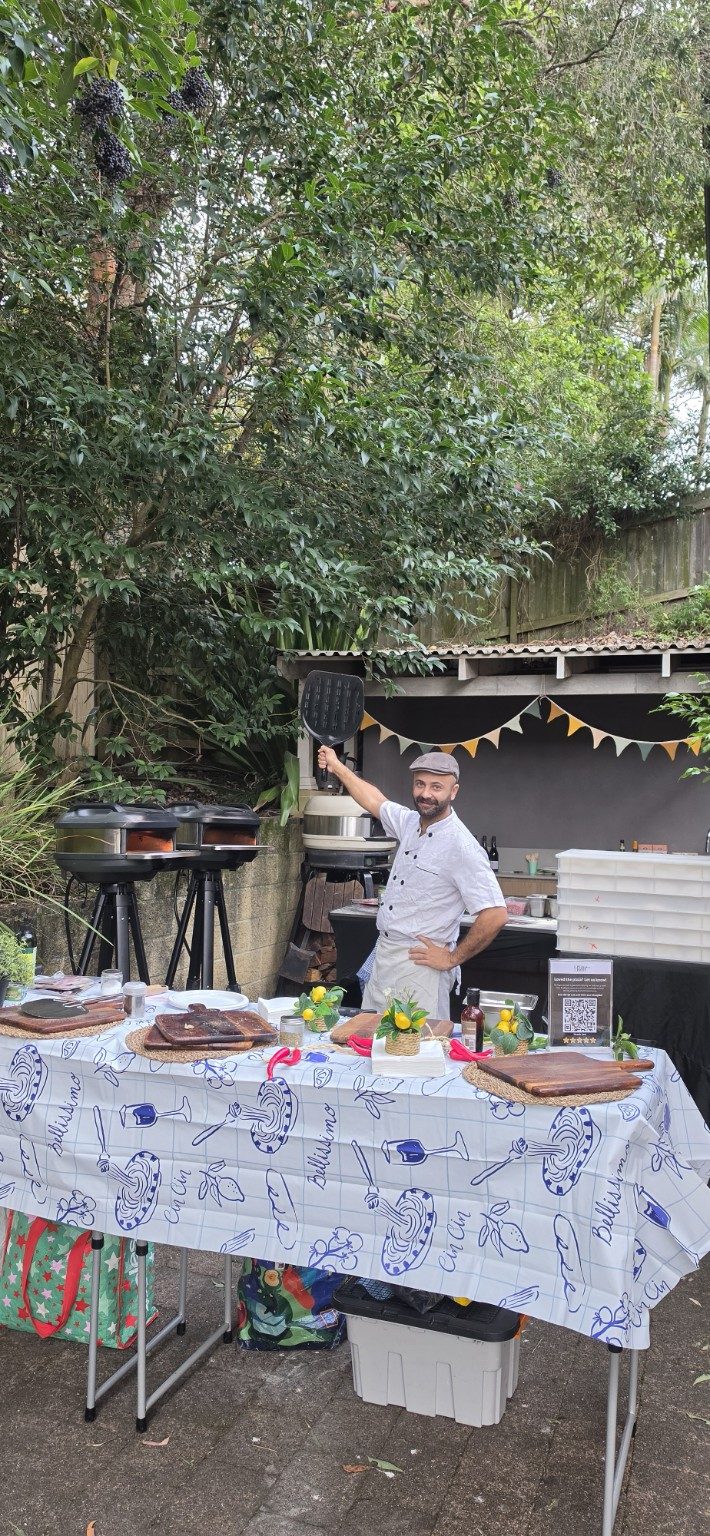 Azzurri pizzaiolo working twin mobile pizza ovens at a private Sydney event, fresh pizza cooked on-site