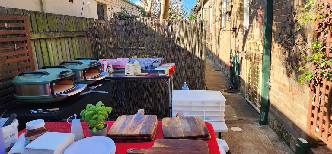 Azzurri Pizza Catering professional mobile setup — authentic Italian pizza ovens, fresh basil, La Stella mozzarella, wooden cutting boards ready for a Sydney event